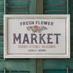 a sign that is on the side of a door saying market seeds stems blooms locally grown