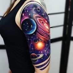 a woman's arm with an image of planets and stars on it