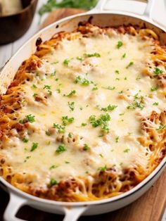 a casserole dish with meat, cheese and parsley