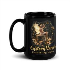 a black coffee mug with an image of a fairy sitting on top of a mushroom