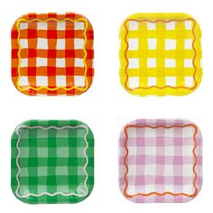 four different colored plates with scalloped edges on white background, including one in green, yellow and pink