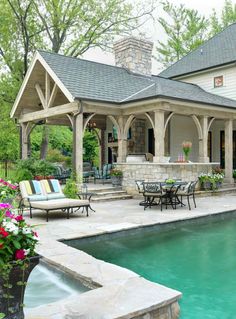 an outdoor pool and patio with seating area