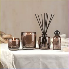 an assortment of candles sitting on top of a table