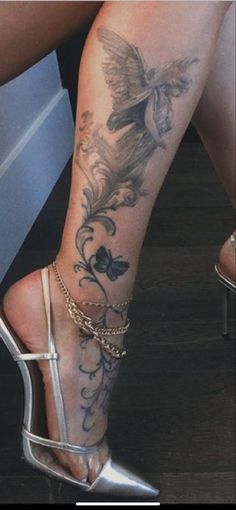 a woman's legs with tattoos and high heels