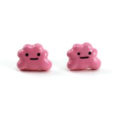 two small pink candy candies with faces drawn on them, sitting side by side