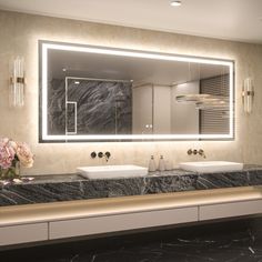 a bathroom with two sinks and a large mirror on the wall over it's counter