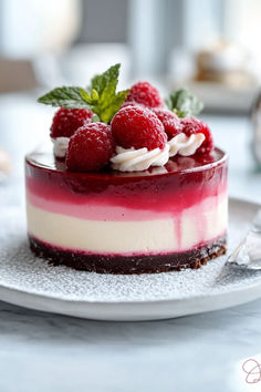 a dessert with raspberries and whipped cream on top