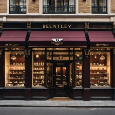 a store front with many items on display in the windows and below awnings