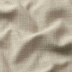 an up close shot of the texture of a linen material, which is light brown