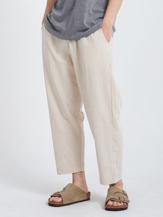 Editor's NotesLinen Cropped Pants Light Beige from PAPERBOY are linen pants made with a relaxed silhouette at the hips. You can adjust the size with a string at the waist. Deformation was minimized through bio-washing. There are pockets on each side and one pocket on one side of the hip.- 15 wt. cotton thread- Pocket details- String detail- High quality fabricMeasurements (in.)- Size: S / M / L / XL- Length: 35.4 / 35.8 / 36.2 / 36.6 in.- Waist: 13.3~16.9 / 14.1~17.7 / 14.9~18.5 / 15.7~19.2 in.- Thigh: 13.7 / 14.1 / 14.5 / 14.9 in.- Crotch: 14.1 / 14.5 / 14.9 / 15.3 in.- Hem: 6.7 / 7.0 / 7.2 / 7.4 in.*Model InformationMan- Height: 6'0 Weight: 132.2 lbs. Size: LWoman- Height: 5'4 Weight: 99.2 lbs. Size: SComposition & Care- 55% Linen, 45% Cotton- Dry Clean OnlyDesigner- by PAPERBOY Casual Flax Bottoms For Summer, Casual Summer Flax Bottoms, Casual Summer Bottoms In Flax, Beach Cotton Bottoms In Flax Color, Casual Ramie Bottoms With Relaxed Fit, Comfortable Loose Fit Linen Harem Pants, Casual Flax Relaxed Fit Pants, Comfortable Linen Harem Pants For Spring, Casual Relaxed Fit Flax Pants