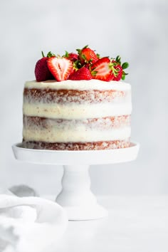 a cake with white frosting and strawberries on top