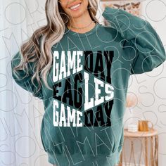 a woman wearing a sweatshirt that says game day eagles gameday