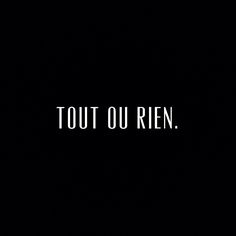 the words tout ou rin are written in white on a dark black background