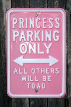 a pink sign that says princess parking only all others will be toaded on it