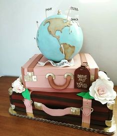 a cake made to look like a suitcase with a globe on top