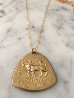 Amazing vintage brass zodiac necklace. The unique shape and 3-dimensional style make this piece a stand out. This is quite a large charm measuring 1 1/4 tall and 1 1/4 at the widest point across. You can purchase this piece alone or with one of our great rectangular of our 18 inch gold filled chains. We have all signs available with the exception of Virgo. There is also a story behind these pieces. I live in Los Angeles and 20 years ago I helped gather some vintage jewelry for the movie ALMOST F Téa Leoni, Virgo Jewelry, Vintage Astrology, Tea Leoni, Taurus Necklace, Zodiac Necklace, Zodiac Pendant, Taurus Zodiac, Zodiac Necklaces