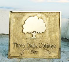 there is a sign that says three oaks cottage