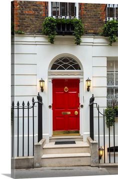 a red door is in front of a white building