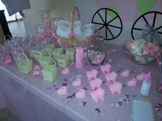 a table topped with lots of candy and candies on top of a purple table cloth