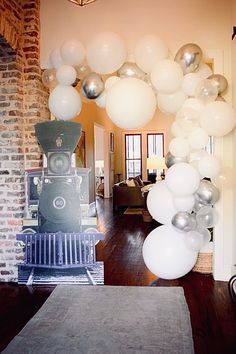 balloons are hanging from the ceiling in this living room