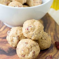 a white bowl filled with cookies and raisins on top of a wooden table