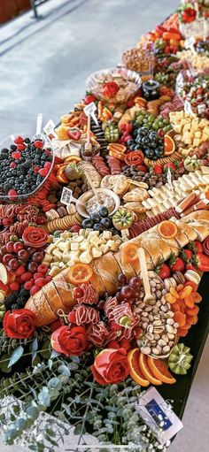 a long table covered with lots of different types of food and fruit on it's sides