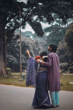 two people standing on the street pointing at something