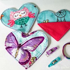 three heart shaped bibs with scissors and sewing supplies