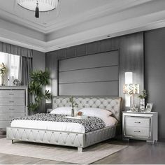 a bedroom with gray walls and white furniture