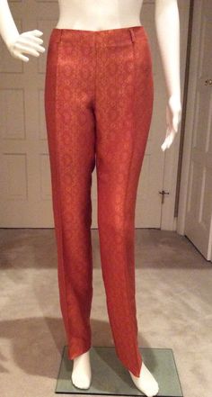 These brocade trousers are meant to be layered under romantic Gigli jackets and renaissance influenced silk vests with a neckline covered in a satin top’s collar. Mix colors,textures, and layers to get the authentic luxury style of Gigli. These trousers are unhemmed so you can do a tall pant cuff, shorten to Capri length, or a plain hem. The waistline sits slightly below the natural waist. There are five 1 1/2” self belt loops. The workmanship is typical of Romeo Gigli. The back of the trousers Elegant Silk Bottoms For Festive Season, Gold Formal Bottoms, Elegant Festive Pants, Formal Silk Fitted Pants, Formal Fitted Silk Pants, Fitted Gold Pants For Evening, Gold Fitted Pants For Evening, Festive Silk Evening Bottoms, Fitted Gold Pants For Festive Season