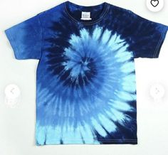 a blue and white tie - dyed t - shirt sitting on top of a table