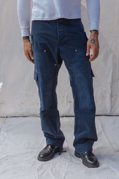 These military inspired pants are equally rugged, stylish, and functional. Cut from a 10 oz 100% cotton herringbone twill and layered with a waxed cotton canvas at the knees and pocket flaps. These pants have been stonewashed for a lived in appearance and feel that stripped the waxed panels leaving an authentic patina behind. The pants feature two double cargo pockets at the hips, two large cargo pockets at the knee, two rear welt pockets, a full button closure, as well as an adjustable draw cor Military Inspired, Waxed Cotton, Guinea Bissau, Mozambique, Welt Pockets, Cargo Pants, Herringbone, Cotton Canvas, Patina