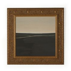 a painting hanging on the wall with a white wall behind it and a brown frame