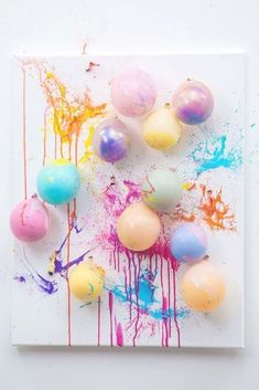 an art work with paint and balloons on it