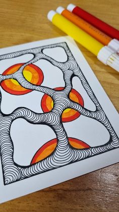 an art work with markers and pencils on a table