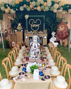 a table set up with mickey mouse decorations