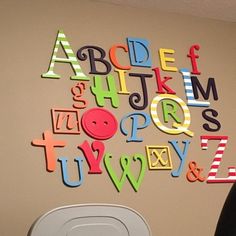 a child's room with letters and numbers on the wall