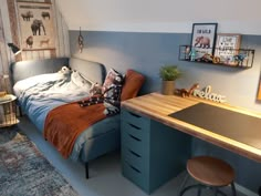 a bed room with a neatly made bed next to a wooden desk and stools