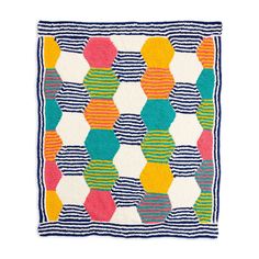 a multicolored rug with stripes and hexagonal shapes