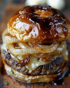 a hamburger with onion rings and cheese on it