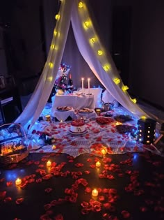 a table is set up with candles and food for a party or wedding reception in the dark