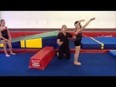 two girls in black leotards and one girl in red is on a trampoline