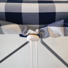 the back of a chair with a blue and white checkered fabric