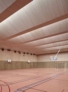 an indoor basketball court is shown with no people in it and there are several hoops on the floor