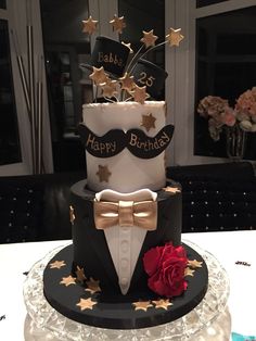 a three tiered cake decorated with stars and bow ties