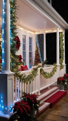 christmas decorations on the front porch of a house with lights and garlands around it