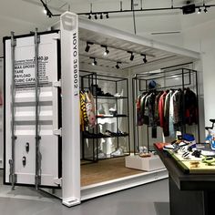 the inside of a clothing store with clothes on display