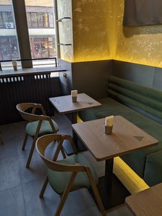 a restaurant with green booths and wooden tables