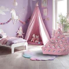 a child's bedroom decorated in pink and purple