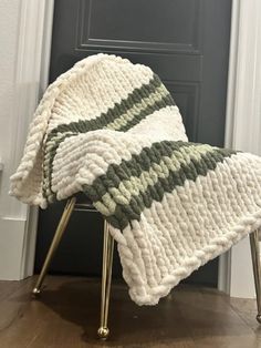 a blanket sitting on top of a chair in front of a door